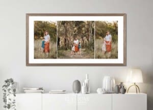 An oak framed print of a family portrait hangs above a hall table