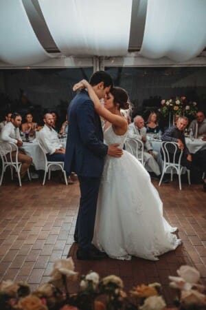 A newly married couple share their first dance surrounded by guests during their Burnham Grove reception
