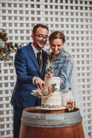 A couple cut their wedding cake during the reception at Burnham Grove