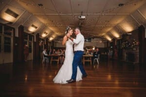 A bride and groom share their first dance during the wedding reception at Audley Dancehall