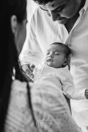 Parents admiring their newborn during a gentle studio session with an Ingleburn photographer