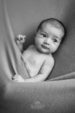 Baby laying on a soft blanket in the Ingleburn natural‑light studio, taken by a newborn photographer