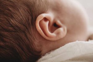 Close view of a newborn's ear captured by an Ingleburn newborn photographer in natural light